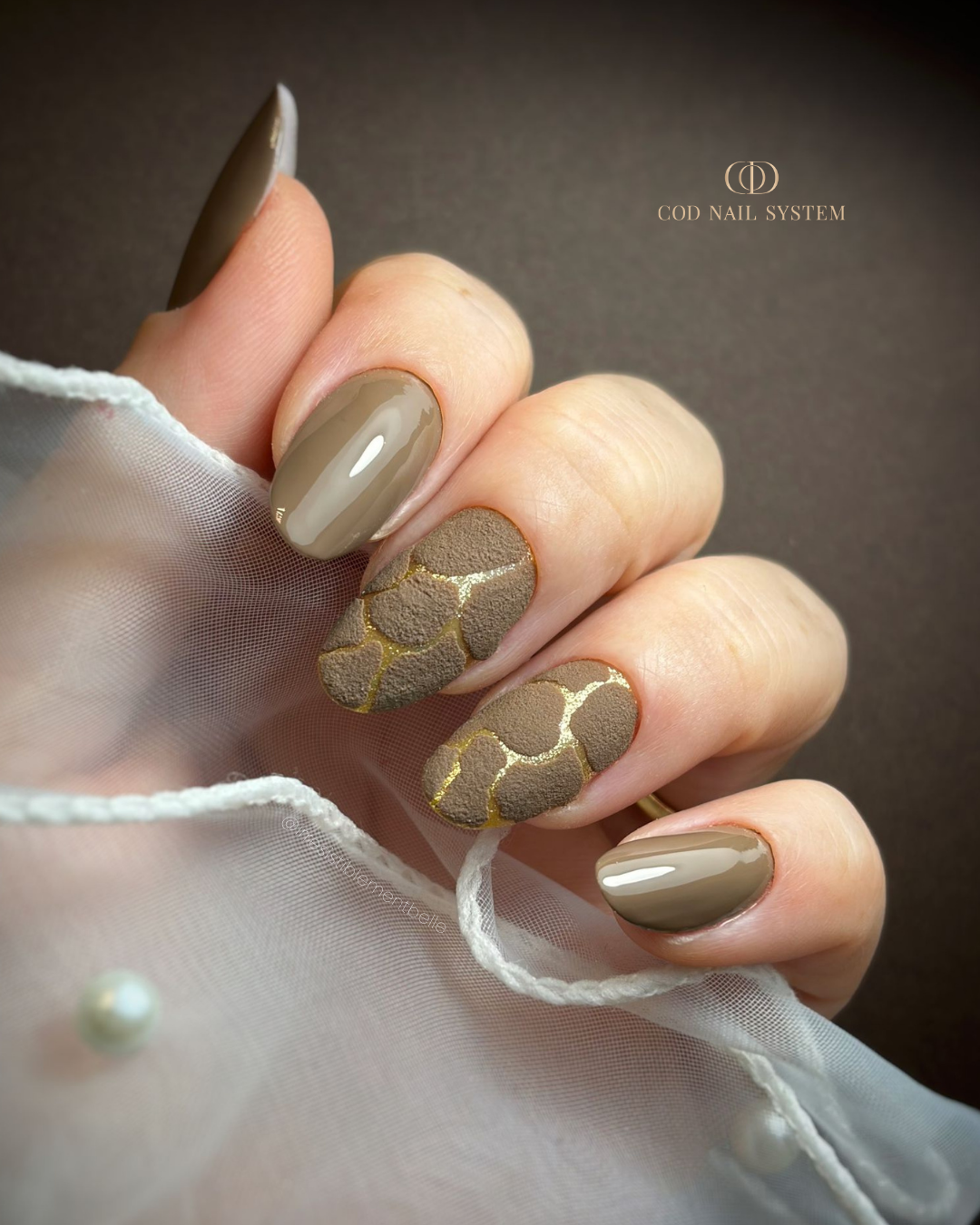 Pose d'ongles en amandes marron taupe avec effet velours doré Pose d'ongles en amandes marron taupe avec effet velours doré
