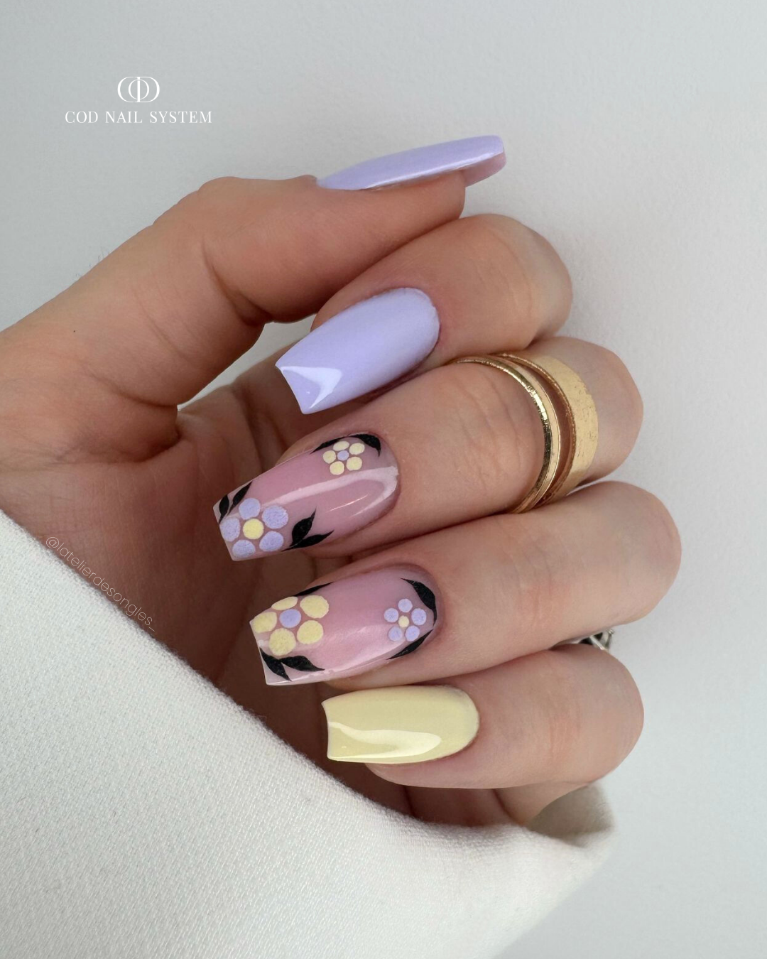 Pose d'ongles coffin violet et jaune pastel avec nail art fleurs en effet velours