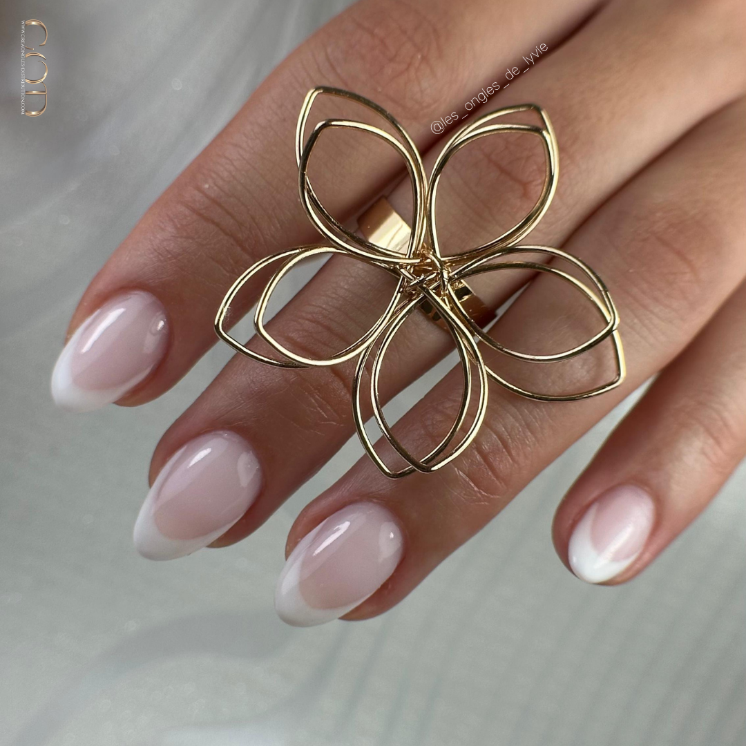 Pose d'ongles en amandes nude rose avec french manucure blanche