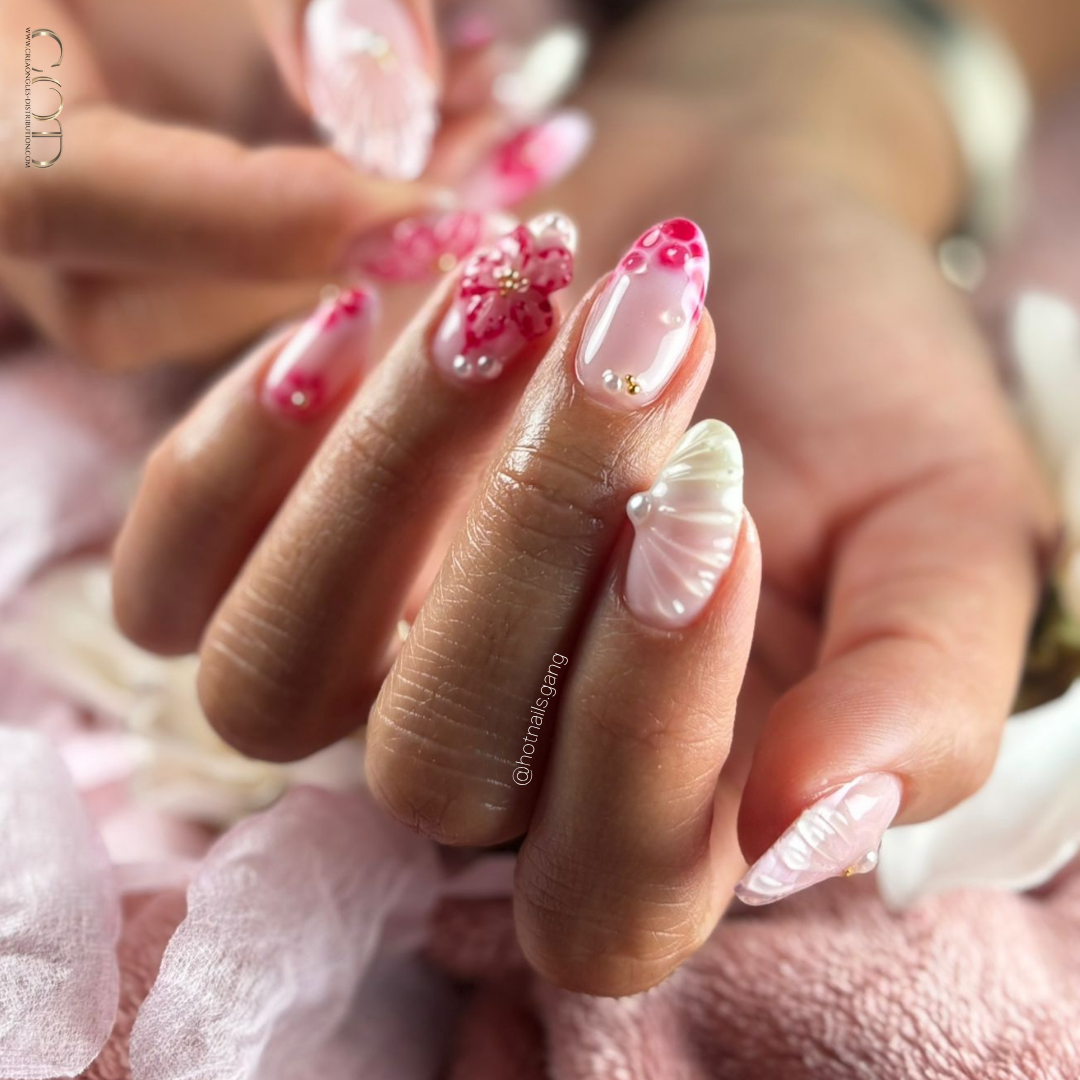 Pose d'ongles en amande roses avec nail art 3D et blossom
